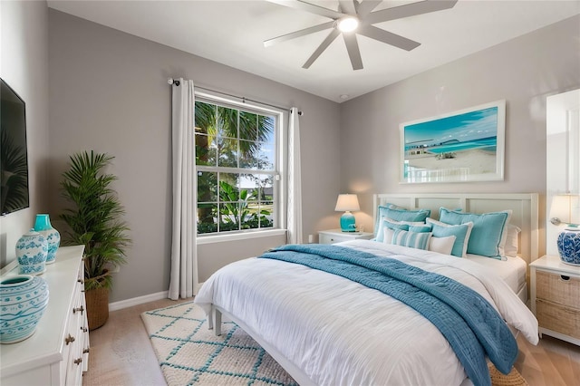 carpeted bedroom with ceiling fan and multiple windows