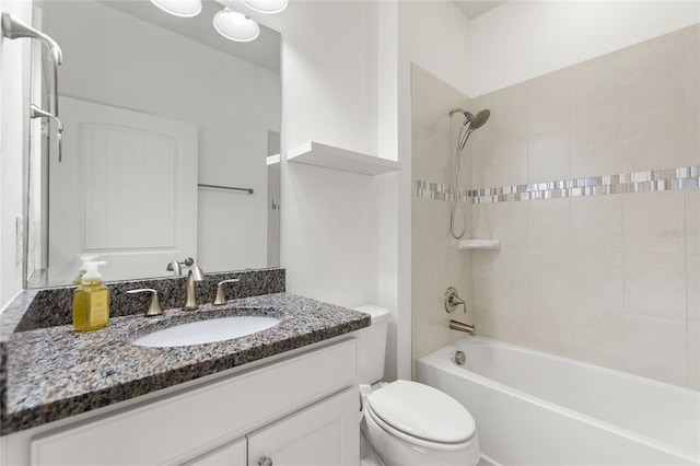 full bathroom with toilet, tiled shower / bath, and vanity