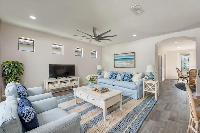 living room with light hardwood / wood-style floors and ceiling fan