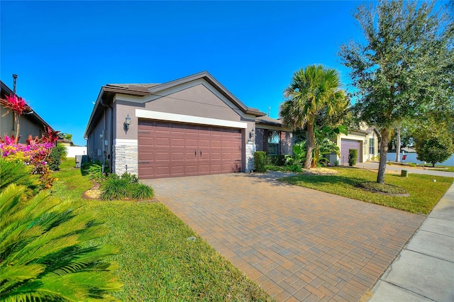 ranch-style home featuring a front yard and a garage