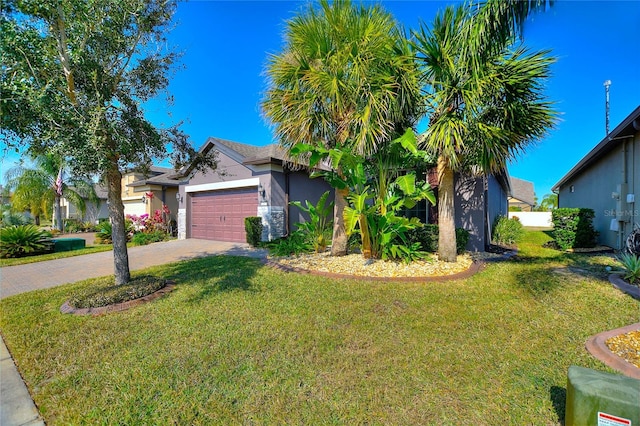 view of front of home featuring a garage and a front lawn