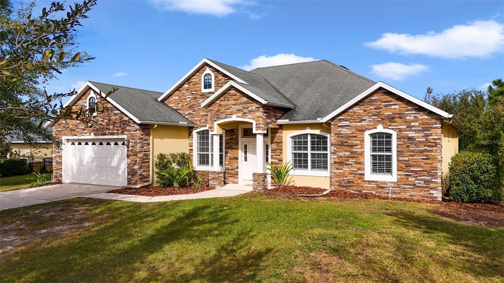 view of front of home featuring a garage and a front lawn