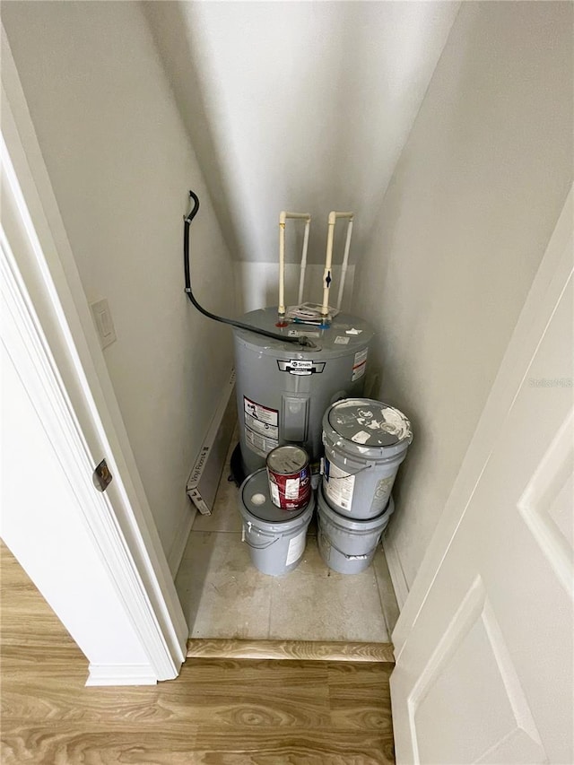 utility room featuring electric water heater