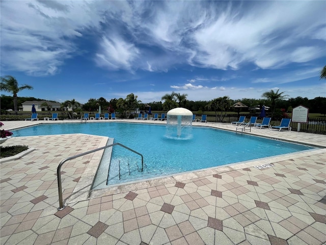 view of pool with a patio area and pool water feature