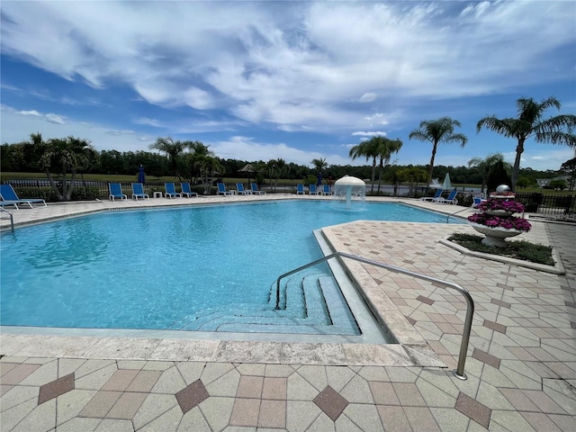 view of swimming pool featuring a patio area and pool water feature