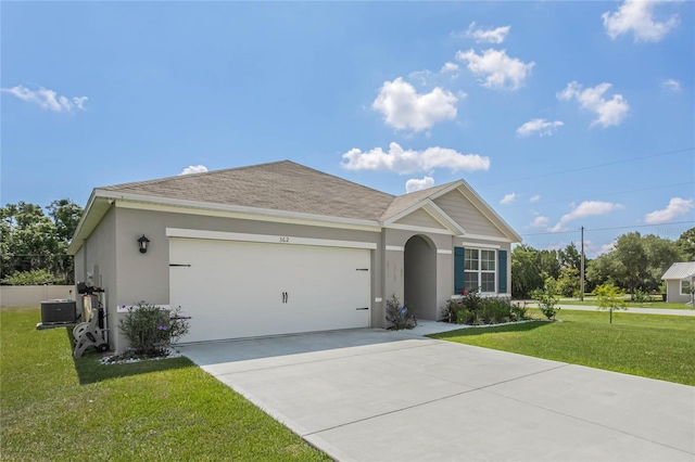 view of front of home featuring cooling unit, a garage, and a front lawn