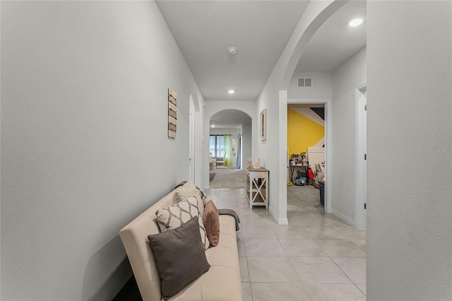 hallway featuring light tile patterned floors