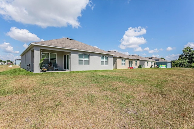 rear view of house with a lawn