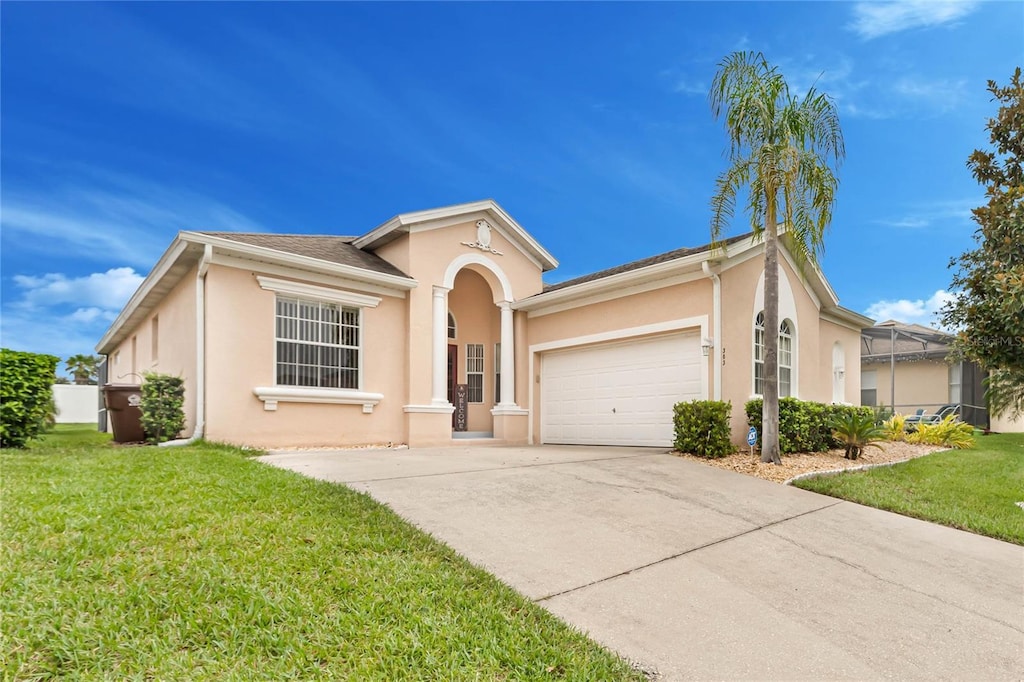 view of front of home with a garage and a front lawn