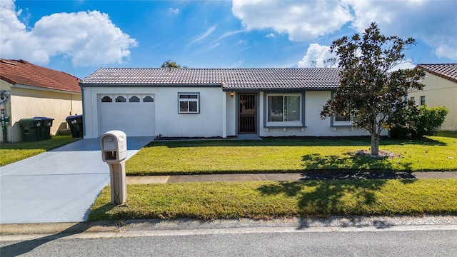 view of front of property featuring a front yard and a garage