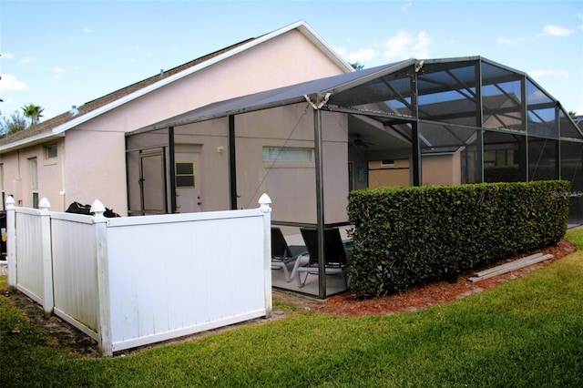 rear view of property with glass enclosure