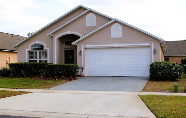 view of front facade with a front yard and a garage