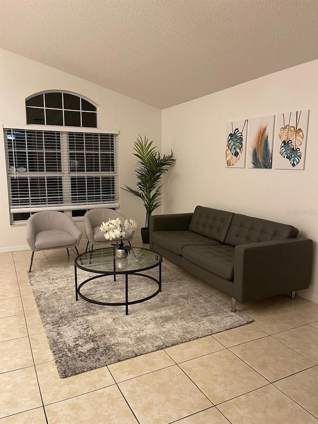 living room featuring light tile patterned floors and a textured ceiling