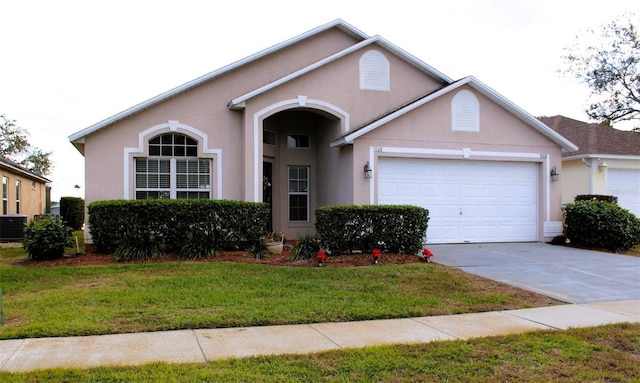 view of front of house featuring central AC, a front yard, and a garage