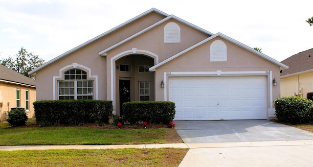 view of front of home with a front lawn and a garage