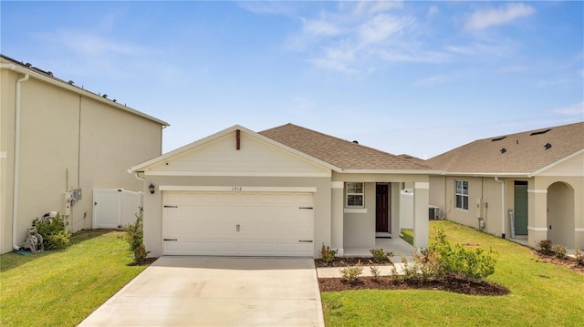 ranch-style house with a front lawn, a garage, and central AC unit