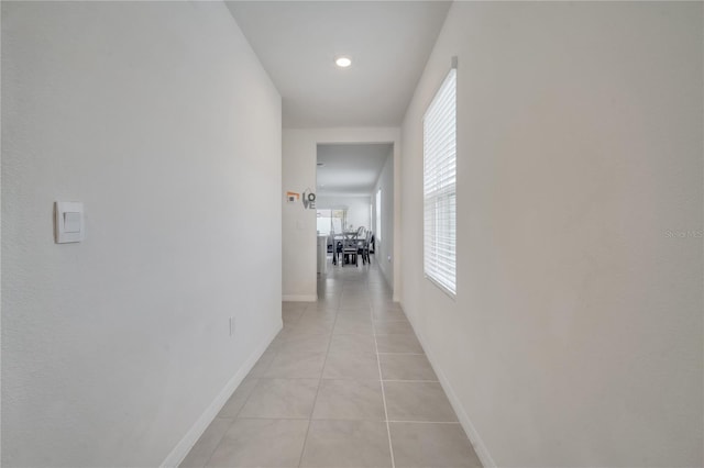 hall with light tile patterned floors