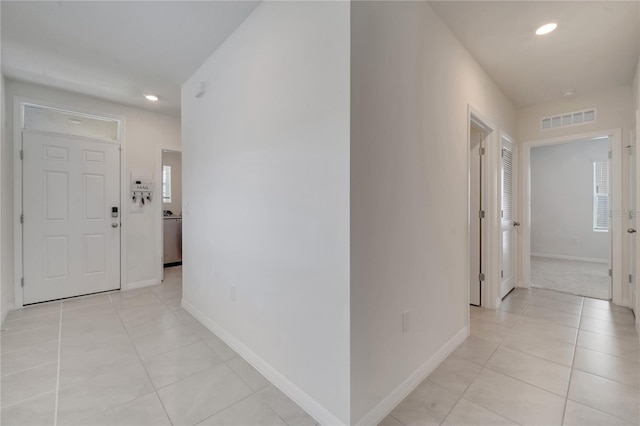 hallway featuring light tile patterned floors