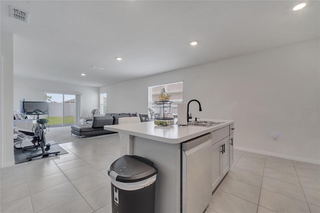 kitchen featuring dishwasher, a kitchen island with sink, white cabinets, sink, and plenty of natural light