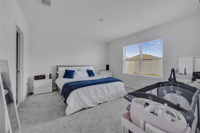 bedroom with light colored carpet