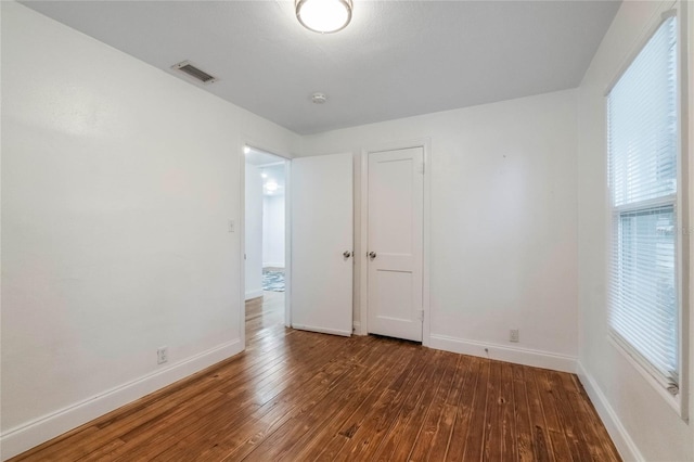 empty room with hardwood / wood-style floors