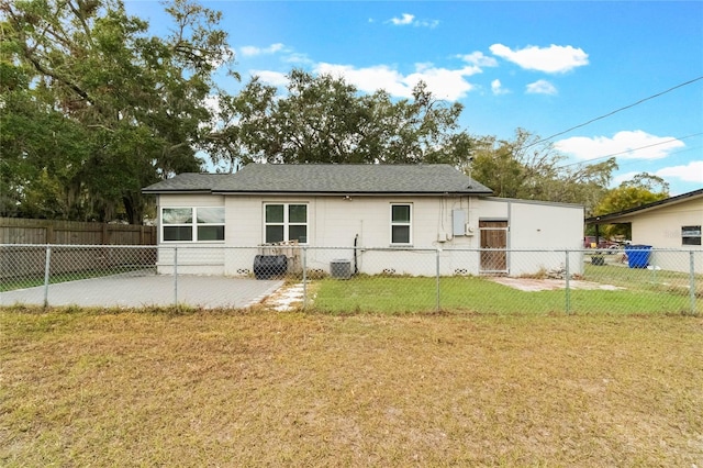 rear view of house with a patio area, a yard, and central AC unit