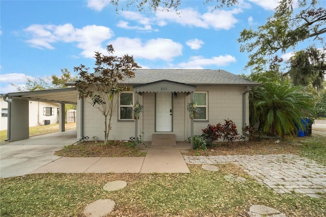 ranch-style home featuring a carport