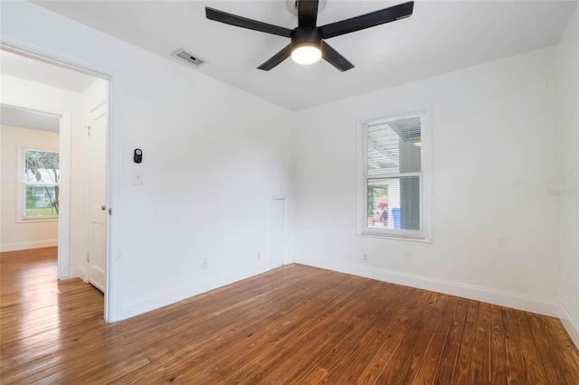 spare room featuring hardwood / wood-style flooring, a wealth of natural light, and ceiling fan