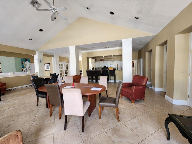 dining room featuring ceiling fan, lofted ceiling, and light tile patterned floors