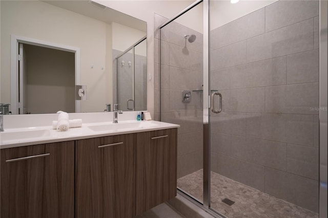 bathroom with vanity and a shower with door