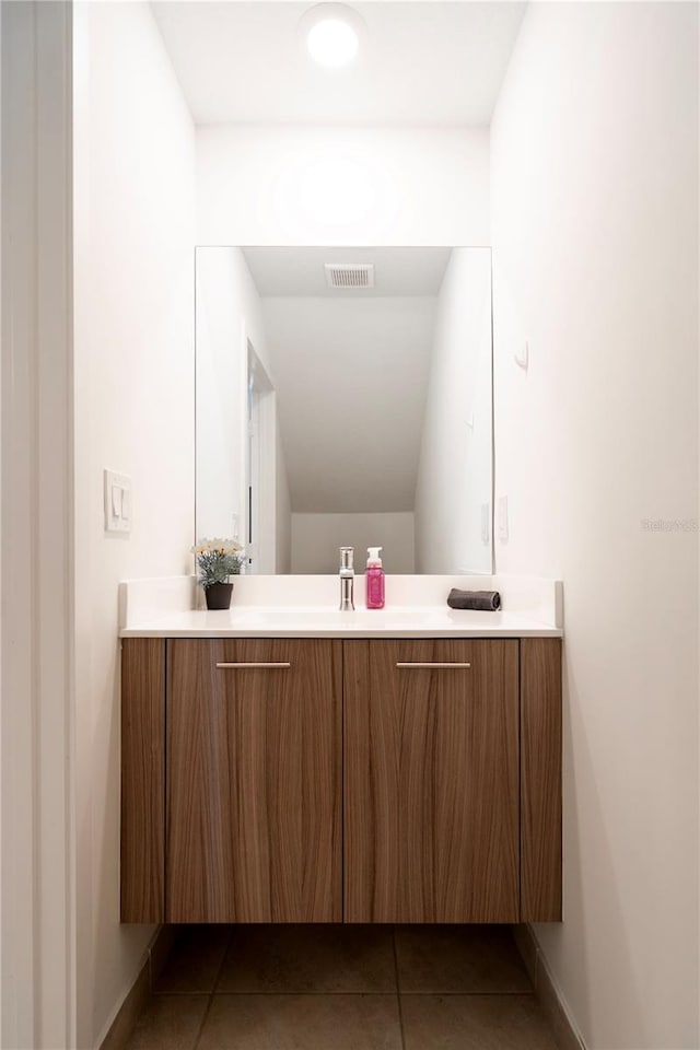 bathroom featuring tile patterned flooring and vanity