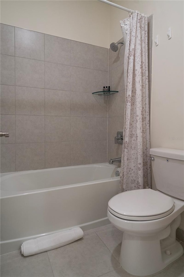 bathroom with tile patterned flooring, toilet, and shower / tub combo