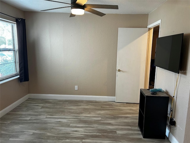 unfurnished room with ceiling fan and light wood-type flooring