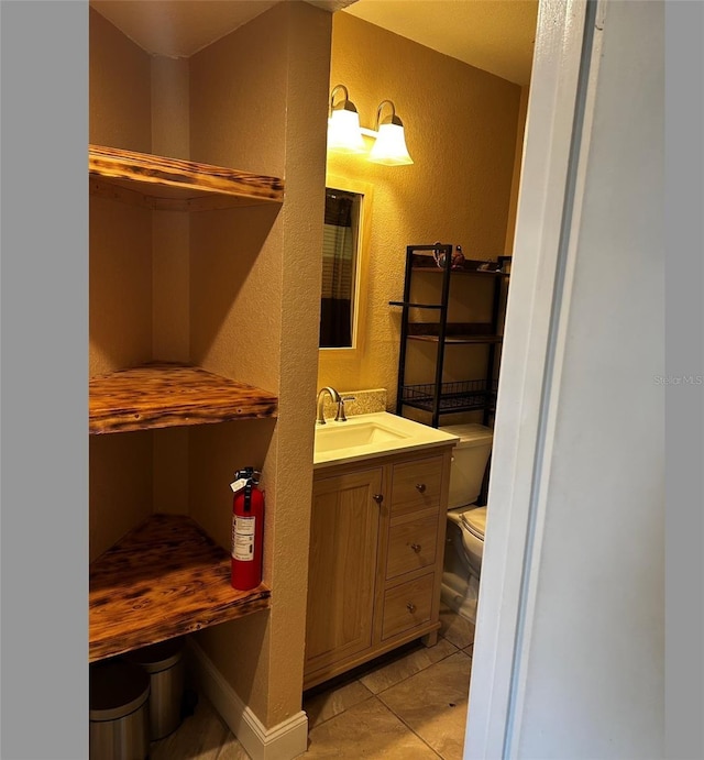 bathroom with tile patterned floors, vanity, and toilet