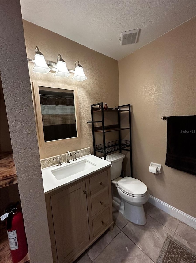 bathroom with tile patterned floors, vanity, a textured ceiling, toilet, and curtained shower