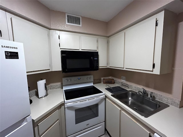 kitchen featuring white cabinets, white appliances, and sink