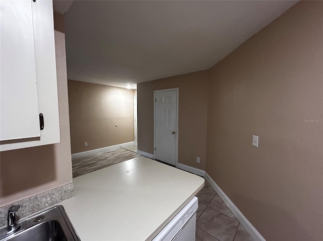 laundry area featuring sink and light tile patterned floors