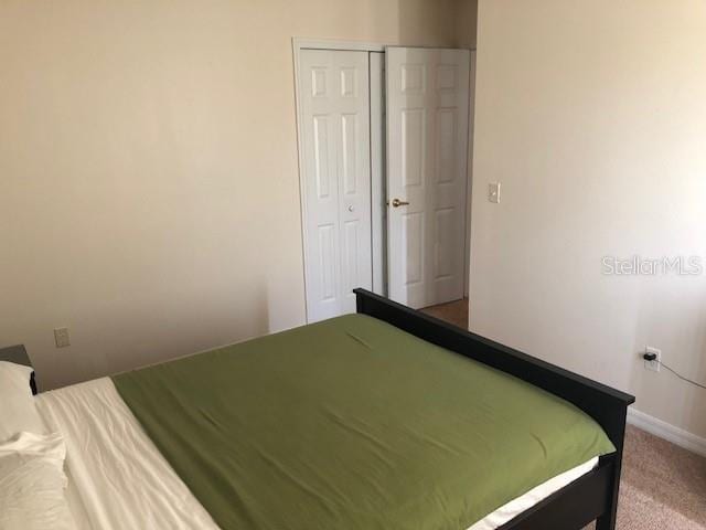 bedroom with carpet floors and a closet