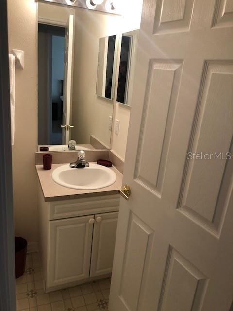 bathroom with tile patterned flooring and vanity