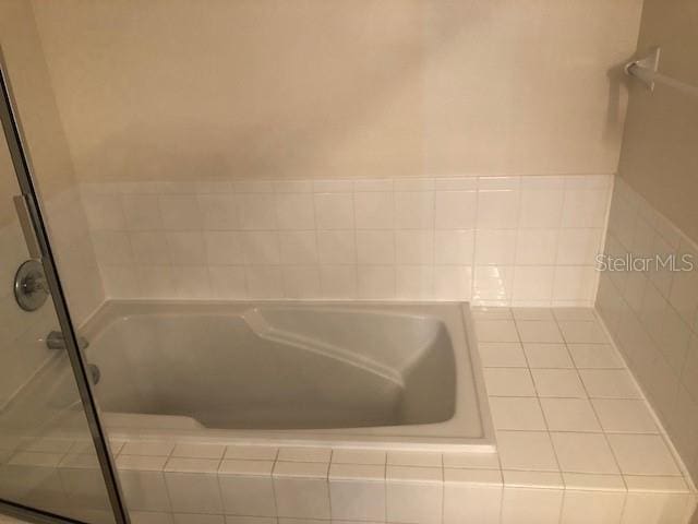 bathroom featuring a relaxing tiled tub