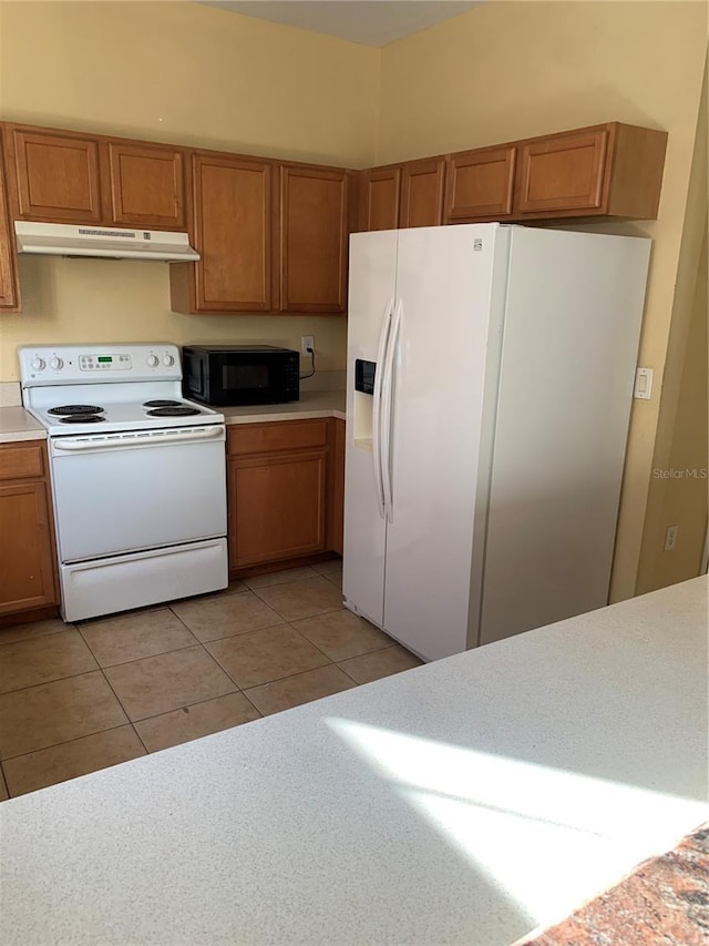 kitchen featuring white appliances and light tile patterned floors