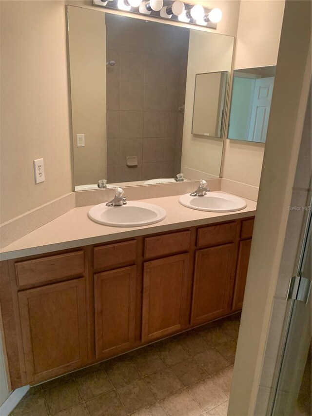 bathroom featuring a shower with door and vanity