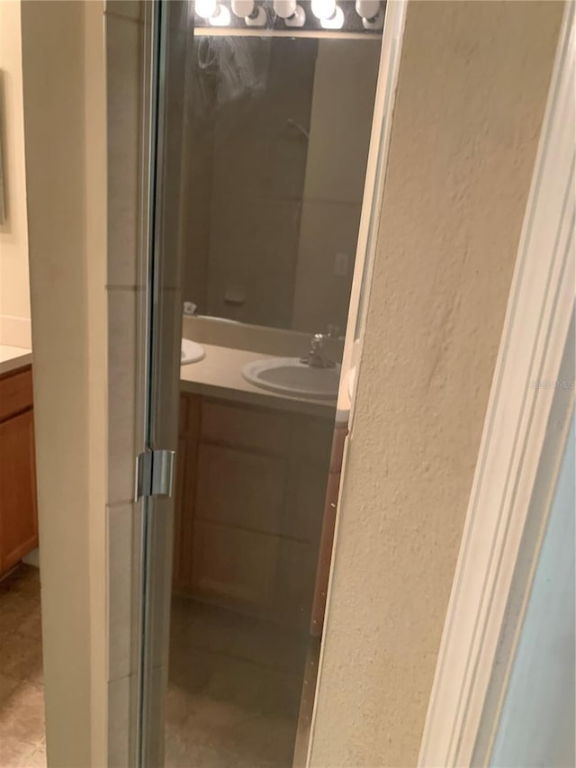 bathroom with vanity and an enclosed shower