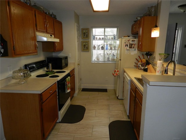 kitchen featuring decorative light fixtures and white appliances