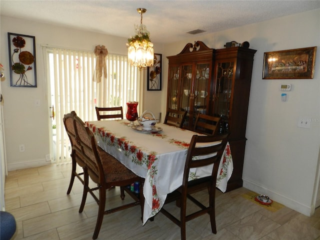 dining space featuring an inviting chandelier