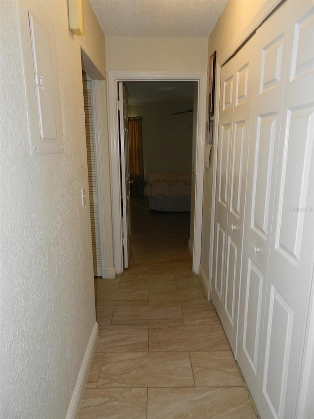 corridor with a textured ceiling