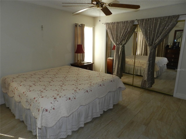 bedroom featuring ceiling fan and a closet