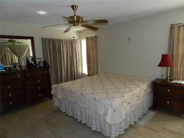 bedroom featuring a textured ceiling and ceiling fan