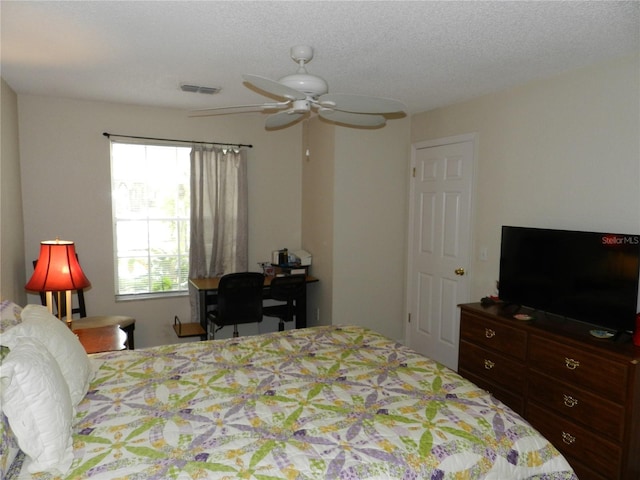 bedroom featuring a textured ceiling and ceiling fan