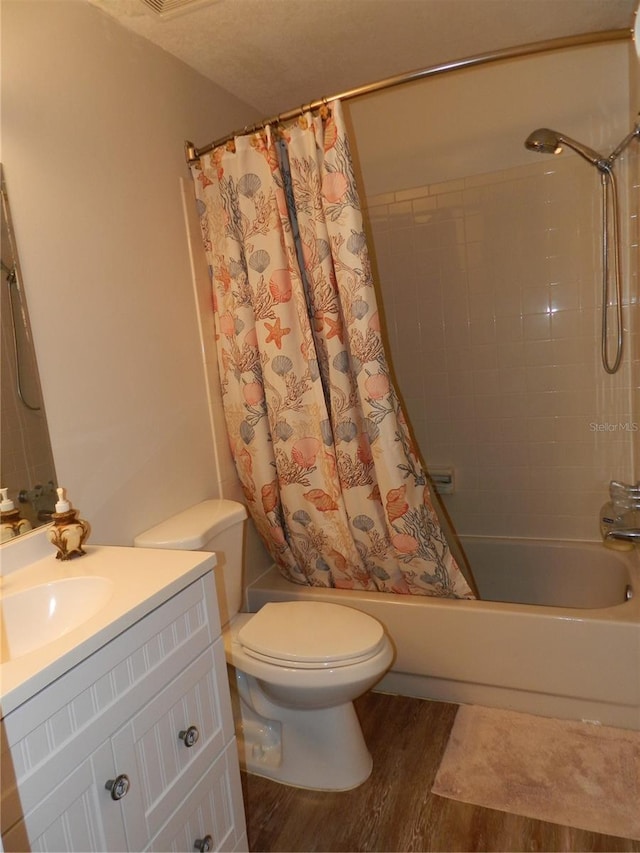 full bathroom with shower / bath combo with shower curtain, vanity, wood-type flooring, and toilet